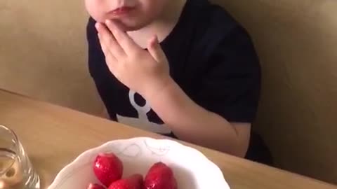 Artem eats strawberries