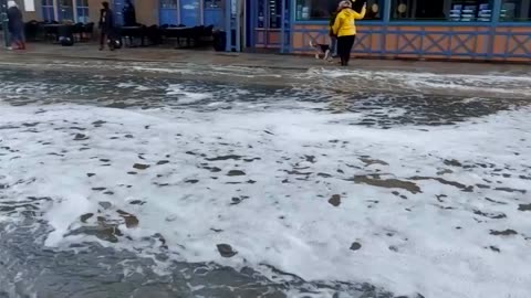 Huge waves crash over seawall flooding Brittany street