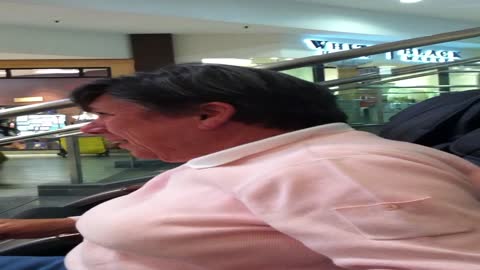 Grandmother Giggles Uncontrollably In Massage Chair At The Mall