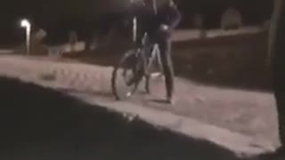 Guy rides bicycle off street onto beach and faceplant