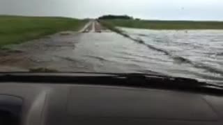Man Drives Straight Through Flooded Road!