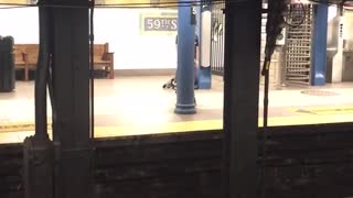 Guy in subway station does a sexy dance to r&b song uses pillar as strip pole