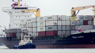 Container ship Vega Kappa sailing at a port in Thailand