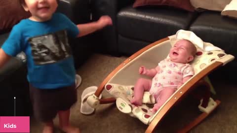 A child tries to playfully feed his baby brother