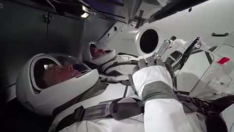 NASA astronauts in new space suits train in SpaceX capsule
