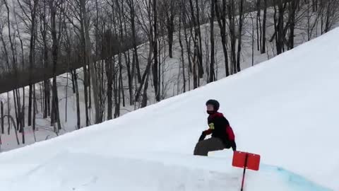 Skier rides down big slope, backflips off ramp, and falls on his butt