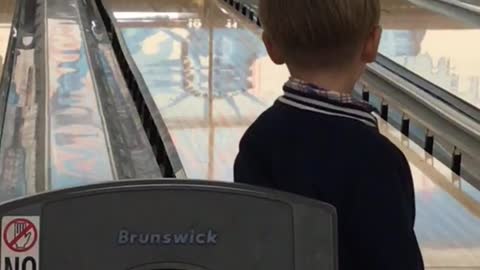 Boy throws orange bowling ball misses last minute