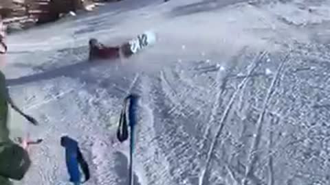 Snowboarder black helmet tries to 360 spin lands on head