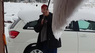 Big wave of snow creeping off roof