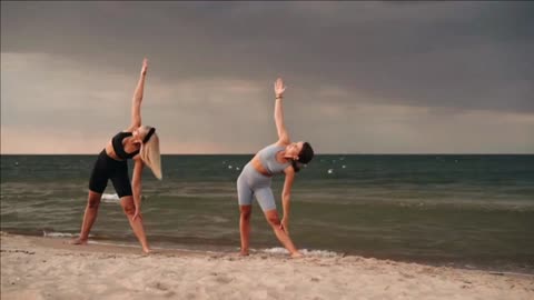 Woman Doing Yoga Over A Rock