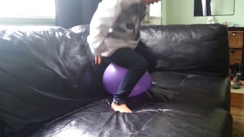 Toddler tries to pop a balloon to no prevail