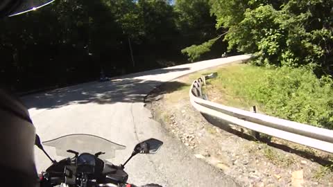 Motorcyclist loses control, almost hits oncoming traffic