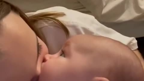 Baby sucks sister nose
