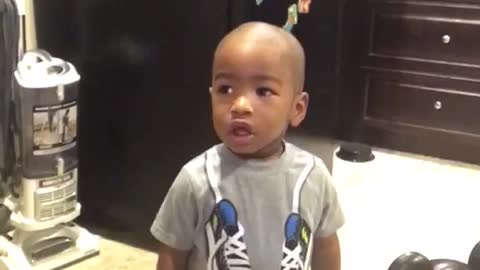 Baby arguing with mommy because he can't figure out how her headset goes in his ear