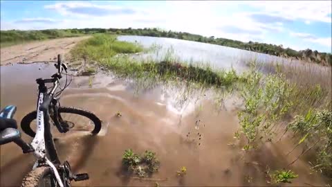 Cyclist Falls in Puddle of Water While Trying to Cross Flooded Patch