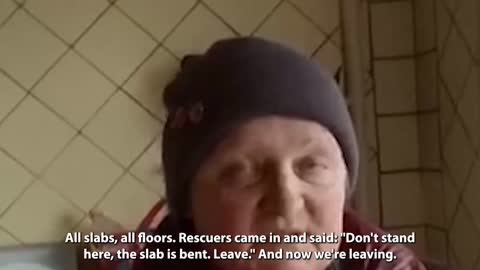 A pensioner from Donetsk shows what's left of her apartment