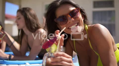 Beautiful Young Girl In Sunglasses Drinking Cocktails With Her Female Friends Relaxing By The Pool