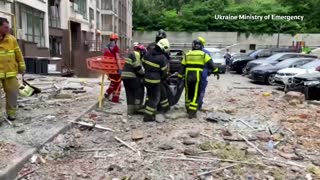 Rescue workers remove body after Kyiv missile strikes