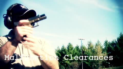 Gun instructor demonstrates techniques from a handgun manual.