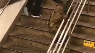 Guy on stairs green jacket trying to walk down slowly