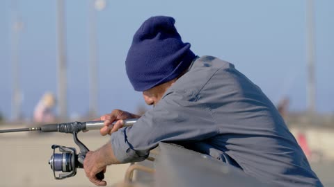 Man Reeling in Fishing Line