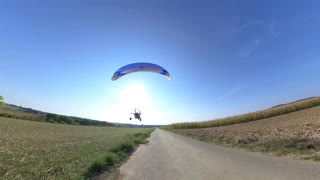 Paramotor Operator Surprises Mountain Board Rider in French Landscape