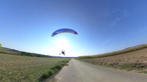 Paramotor Operator Surprises Mountain Board Rider in French Landscape