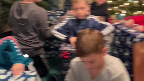 Grandkids opening Christmas gift