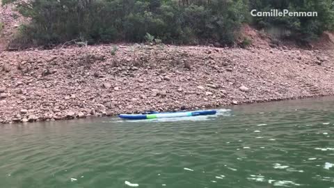 Guy lands on top of a girl on a paddle board