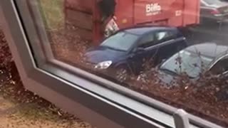 Guy in black shirt trying to toss trash ends up spilling all of it