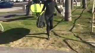 Bunch of guys with surfboards walk to beach