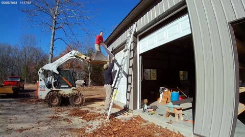 Putting up gutters over the doors.