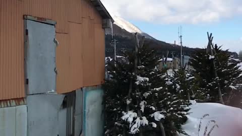 MAN JUMPS OF ROOF INTO SNOW SLOW MOTION