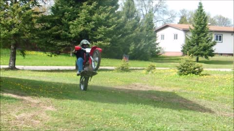 Riding dirt bike in the yard