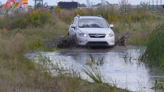 car racing in dirty water and slash