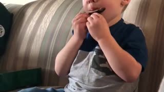 3-year-old boy very proud of his harmonica solo