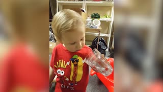Little Boy Is Confused By Decorative Cup
