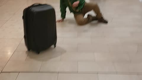 2 MEN RIDING THEIR LUGGAGES HOME