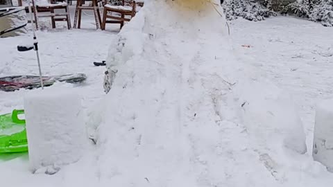 Toddler has funny expression sledding down ice slide