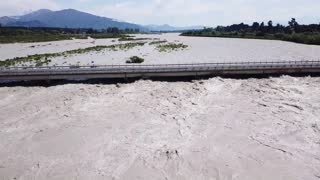 Flooded River Rises To Bridge's Roadway