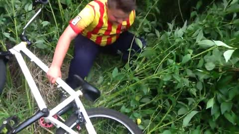 Fat kid rides bike in bush