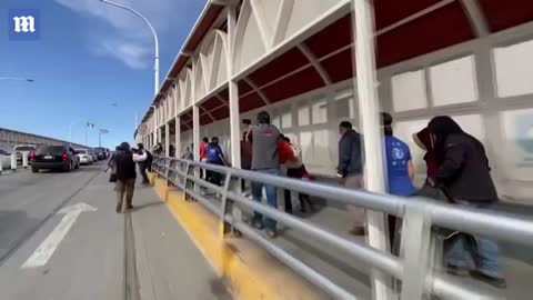 UN officials escorting migrants across US border