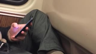 Man rubs his foot on subway train, smelly sock