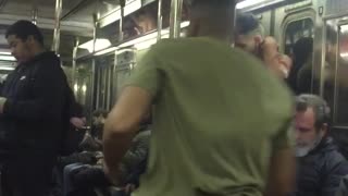 Guy green shirt hanging from subway bars