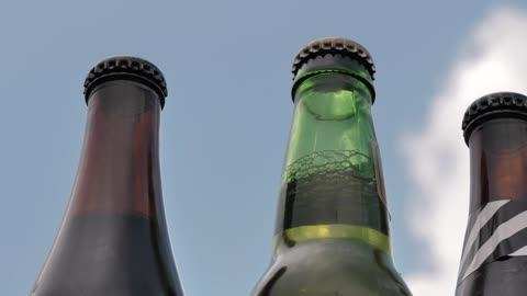 Glass bottles of beer on a sunny day