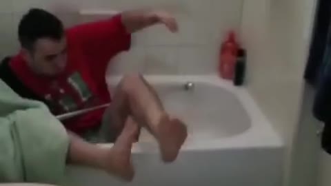 Guy scares guy in red in bathroom