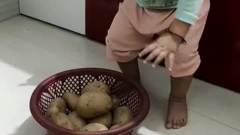 Baby Happily playing with potatoes