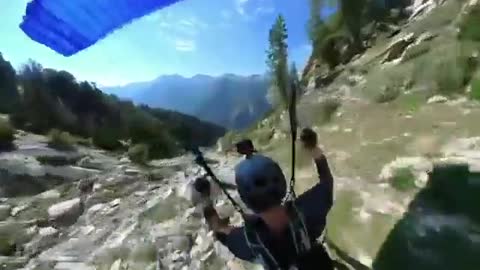 Paraglider Flies and Flips Over Rocks