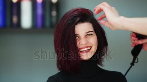 Cute Woman at the hair salon getting a haircut.