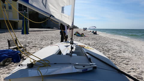 Launching an ILCA Laser Sailboat from Seagate Beach, Naples Florida